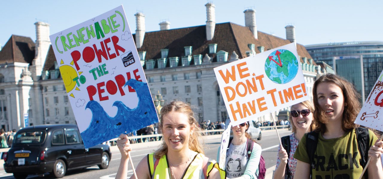 Climate protestors holding up banners