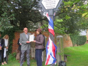 Anne Henshaw, Chairman of CPRE Wiltshire, presents the Laurence Kitching Award certificate to Cllr John Rogers, of Rushall Parish Council