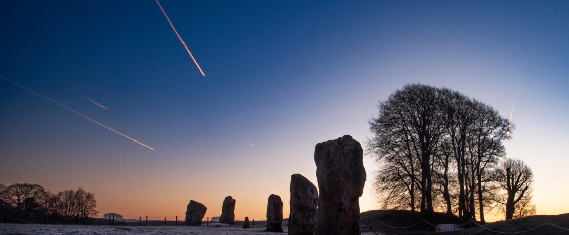 Shooting star over Avebury stones at dawn